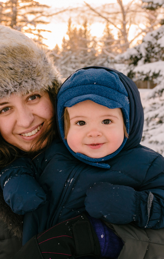cute baby and mom in winter snow