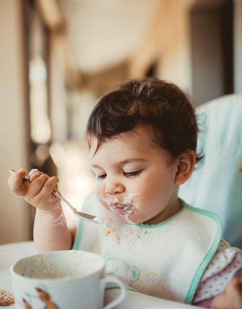 cute baby eating cereal 