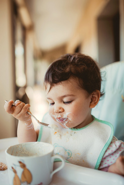 cute baby eating cereal 
