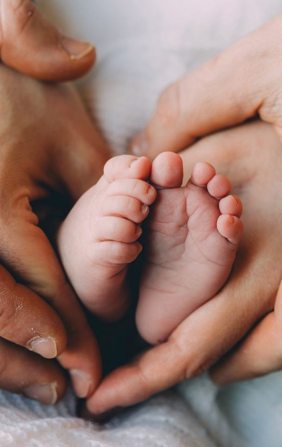 dad holding baby feet